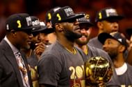 LeBron James #23 of the Cleveland Cavaliers holds the Larry O'Brien Championship Trophy after winning the 2016 NBA Finals.